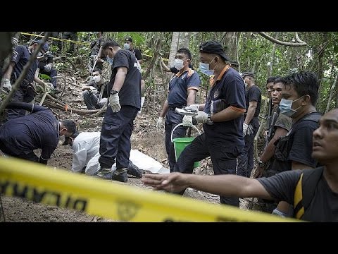 forensic police in malaysia exhume migrant corpses buried