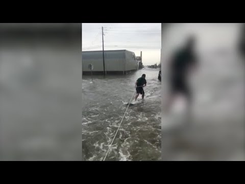 a man riding the floodwaters in galveston